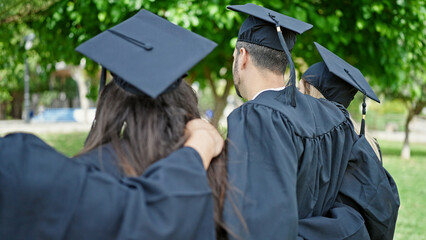 Group of people students graduated hugging each other backwards at university campus