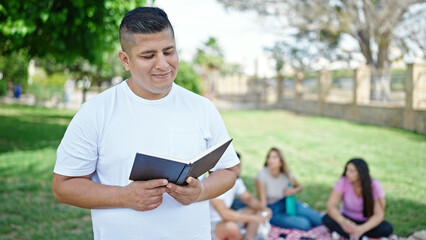 Group of people students reciting book standing at park