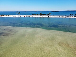 An aerial drone view of Dunedin Causeway beach showing the seagrass at low tide.