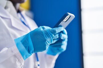 Young african american woman scientist using smartphone at laboratory