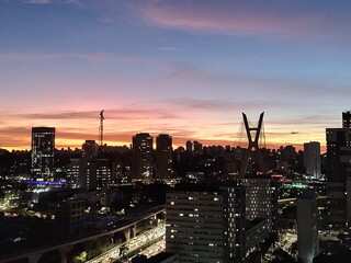 Fototapeta premium Big city with a colors sky and buildings