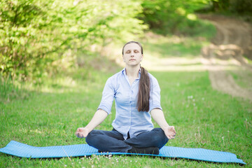 woman meditates in a nature park