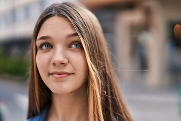 Obraz premium Adorable girl smiling confident looking to the side at street