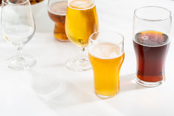 Glass set with light beer dark on light background party concept