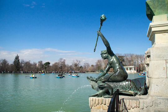 Mermaid fountain of the El Retiro Great Pond with boats in the background. Madrid, Spain.