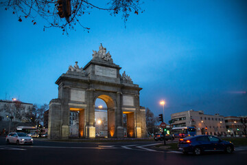 Fototapeta na wymiar Cars passing by Toledo gate at night, Madrid, Spain.