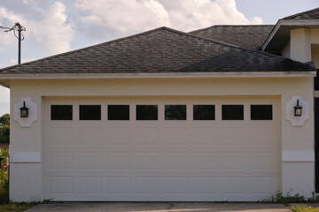 Wide garage double door and concrete driveway of new modern american house