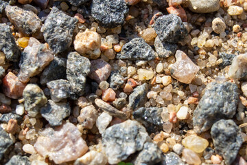 Small pebbles in the sand close up