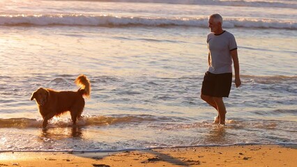 64 year old man getting his exercise at the beach at sunset. Slow Motion.