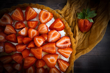 Pie with fresh strawberries on old background