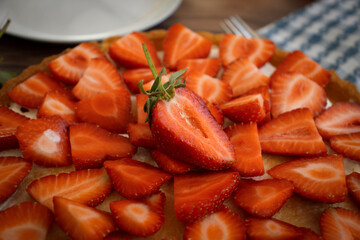 Pie with fresh strawberries on old background