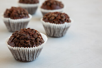 Homemade Dark Chocolate Muffins on a gray background, side view. Copy space.