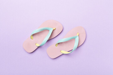 Bright flip flops on color background, top view