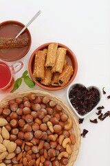 Healthy food, nuts, honey, karkade tea, homemade cookies, with sesame seeds, mint leaf, on a white background, background image, background, wallpaper for presentations