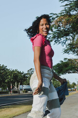 girl smiling and dancing spontaneously in the street, lifestyle urban culture