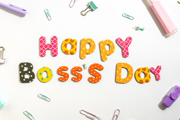 The inscription Happy Boss's day from colored letters on white. top view, flat lay
