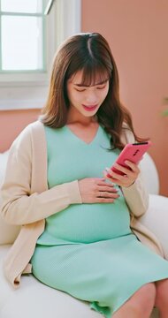 asian woman pregnant scroll mobile