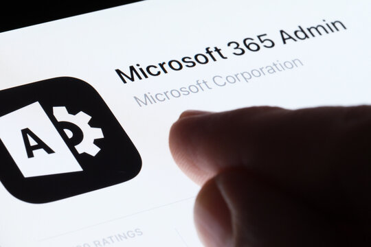 Microsoft 365 Admin app seen in App Store on the screen of ipad and blurred finger pointing at it. Selective focus. Stafford, United Kingdom, May 6, 2023