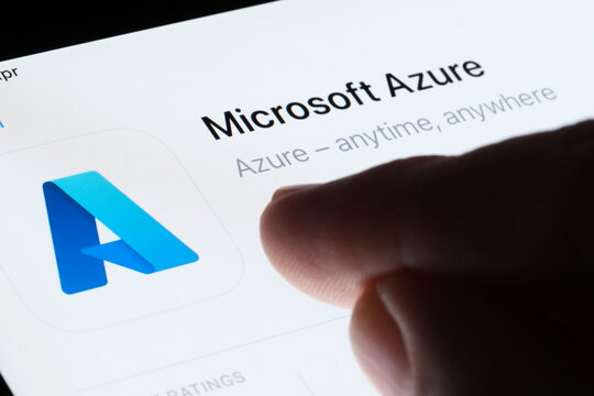 Microsoft Azure app seen in App Store on the screen of ipad and blurred finger pointing at it. Selective focus. Stafford, United Kingdom, May 6, 2023