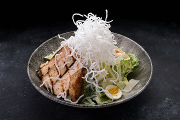 Caesar salad with grilled chicken and crunchy rice chips