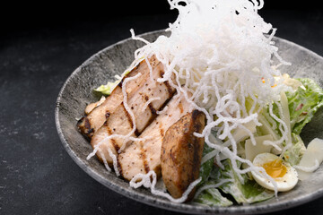 Caesar salad with grilled chicken and crunchy rice chips