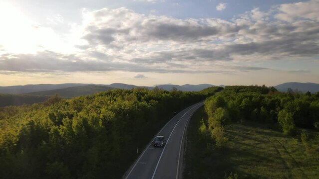 Aerial Drone View Car Driving on Curvy Mountain asphalt Road in Spring