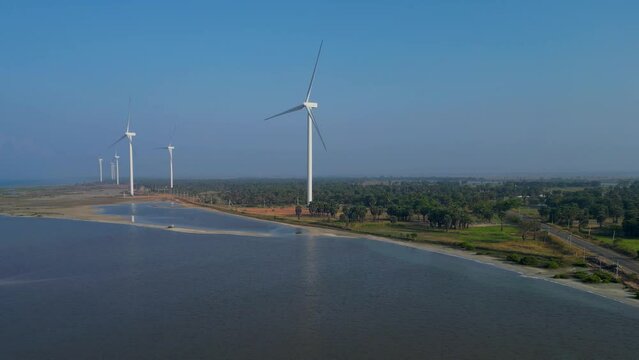 Aerial footage of a windmill by the sea