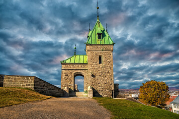 Ancient portal of Old Quebec's fortifications in Canada. Cloudy day during autumn. - 599983929