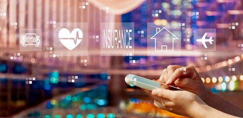 Insurance concept with person using a smartphone in a city at night
