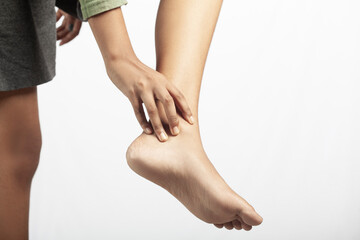 women suffering from ankle joint pain in white background