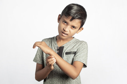 indian child suffering from broken wrist hand pain in white color background