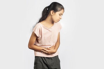 slim indian woman in casual wear clutching her stomach indicating menstrual pain