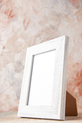 Front close view of white empty wooden photo frame on pastel colors background