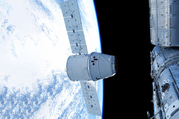 Docking spacecraft in outer space. Elements of this image furnished NASA.
