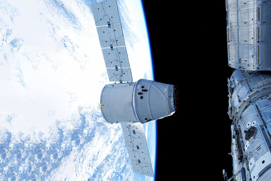 Docking spacecraft in outer space. Elements of this image furnished NASA.