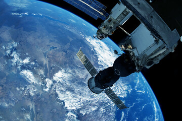 Docking spacecraft in outer space. Elements of this image furnished NASA.