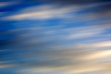 Background of the motion blurry clouds under the beautiful blue sky. Clouds exert numerous influences on Earth's troposphere and climate.
