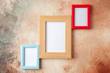 Top view of three photo frames hung on side by side on mix color wall with free space