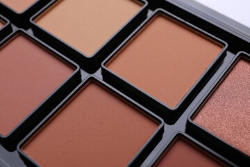 Colorful contouring palette as background, closeup. Professional cosmetic product