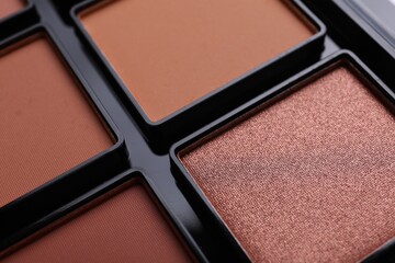 Colorful contouring palette as background, closeup. Professional cosmetic product