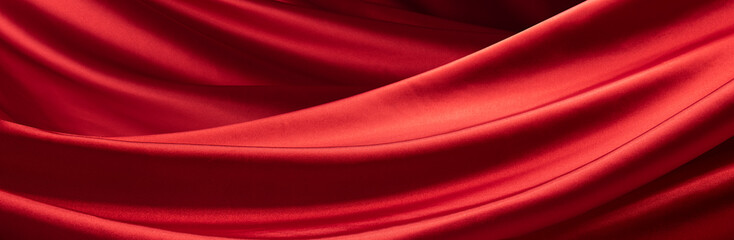 Fototapeta na wymiar ドレープのあるサテンの赤い布の背景テクスチャー