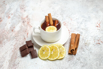 front view cup of tea with lemon slices and chocolate on white background tea drink fruit lemon