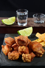 fried pork skin crackling pork pancetta pururuca typical brazilian food with lemon and french fries