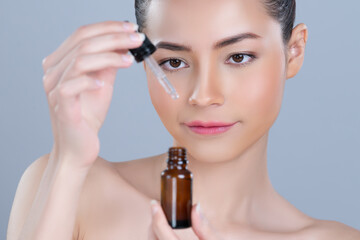 Glamorous closeup beautiful woman applying extracted cannabis oil bottle for skincare product. CBD...