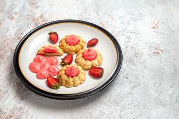 front view delicious sugar cookies with strawberry jelly on white desk jelly fruit cake sugar sweet biscuit