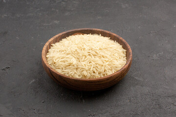 front view raw rice inside brown plate on grey background rice raw meal food east cooking
