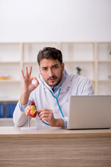 Young male doctor cardiologist working in the clinic