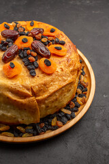 front view tasty shakh plov cooked rice inside round dough with raisins on the grey background rice meal food cooking dough cuisine