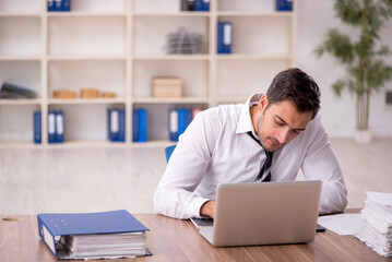 Young male employee working in the office