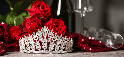 Beautiful tiara with red roses and prom dress on grunge table